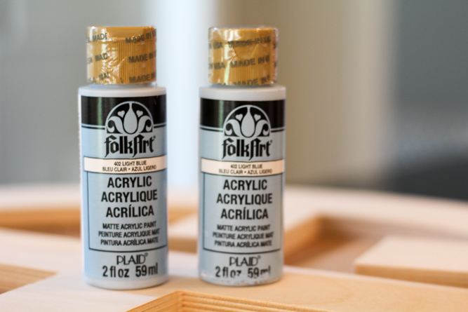 two bottles of folkart craft paint in the color light blue