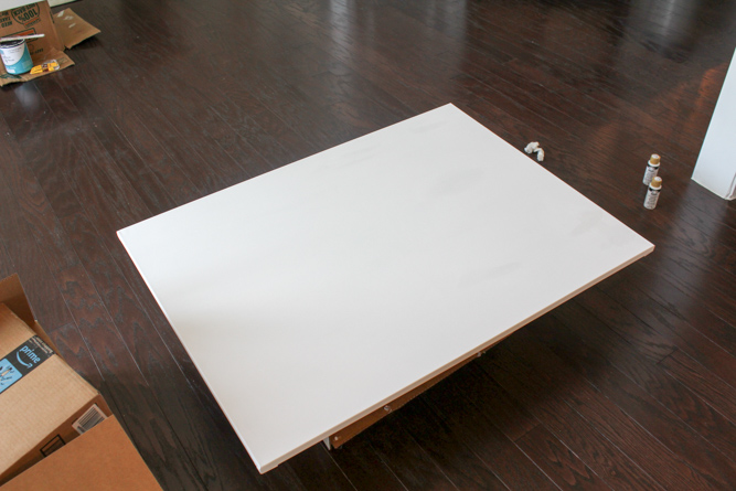 a blank white canvas laying on the floor