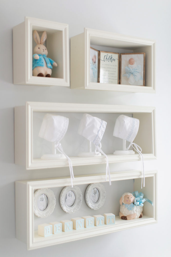 open shelves in a nursery display baby keepsakes and photos