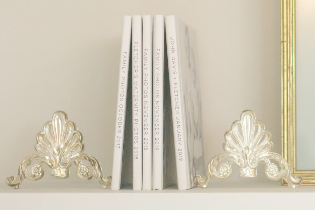 two vintage silver thrift store pieces used as bookends on a shelf 