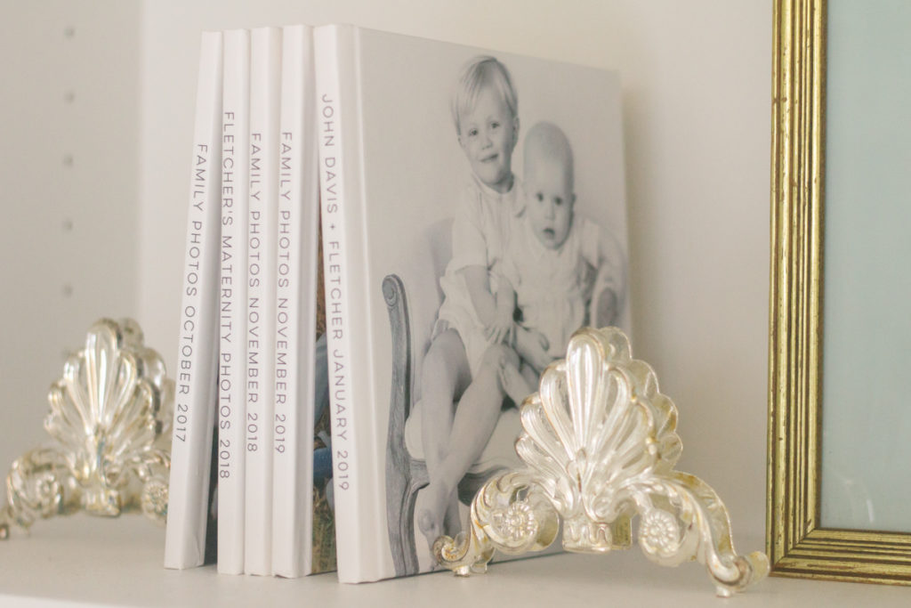 two thrift store silver pieces used as bookends on a shelf 