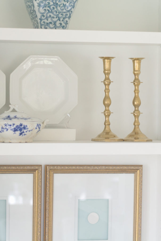 vintage brass candlesticks from the thrift store styled on built in shelves