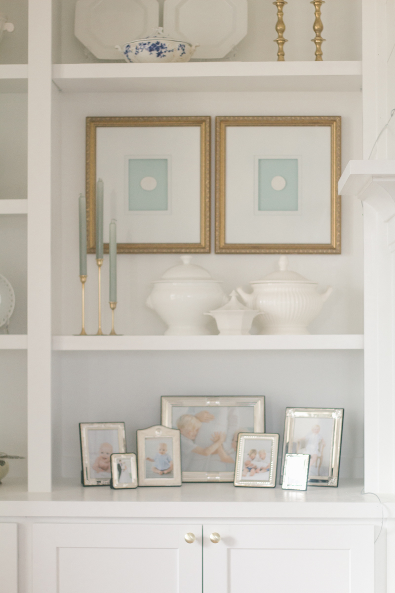 diy framed intaglios hanging on the wall of built in shelves