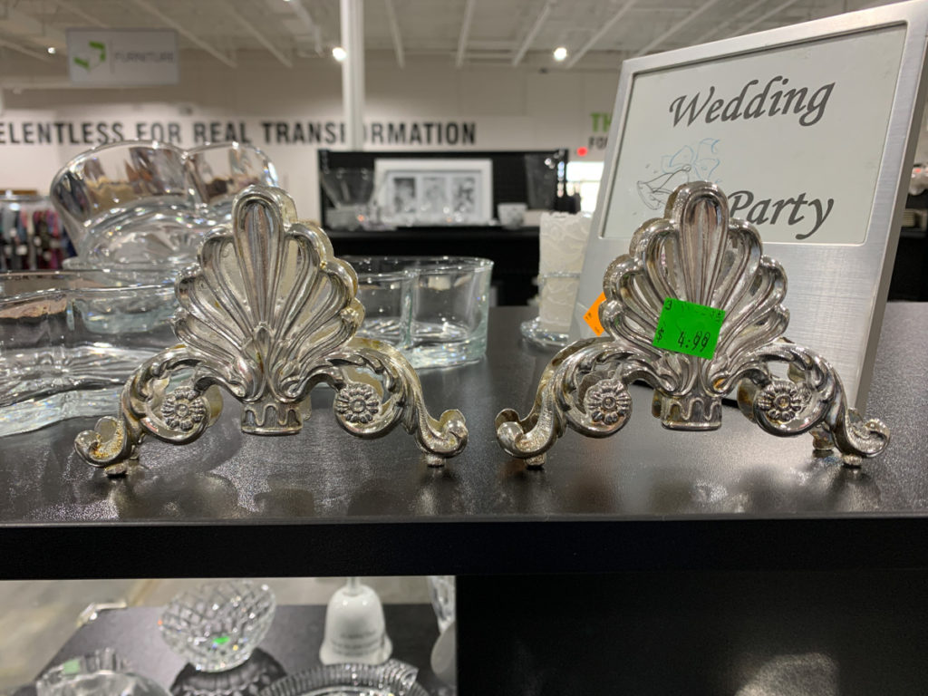 two decorative silver pieces for sale in a thrift store