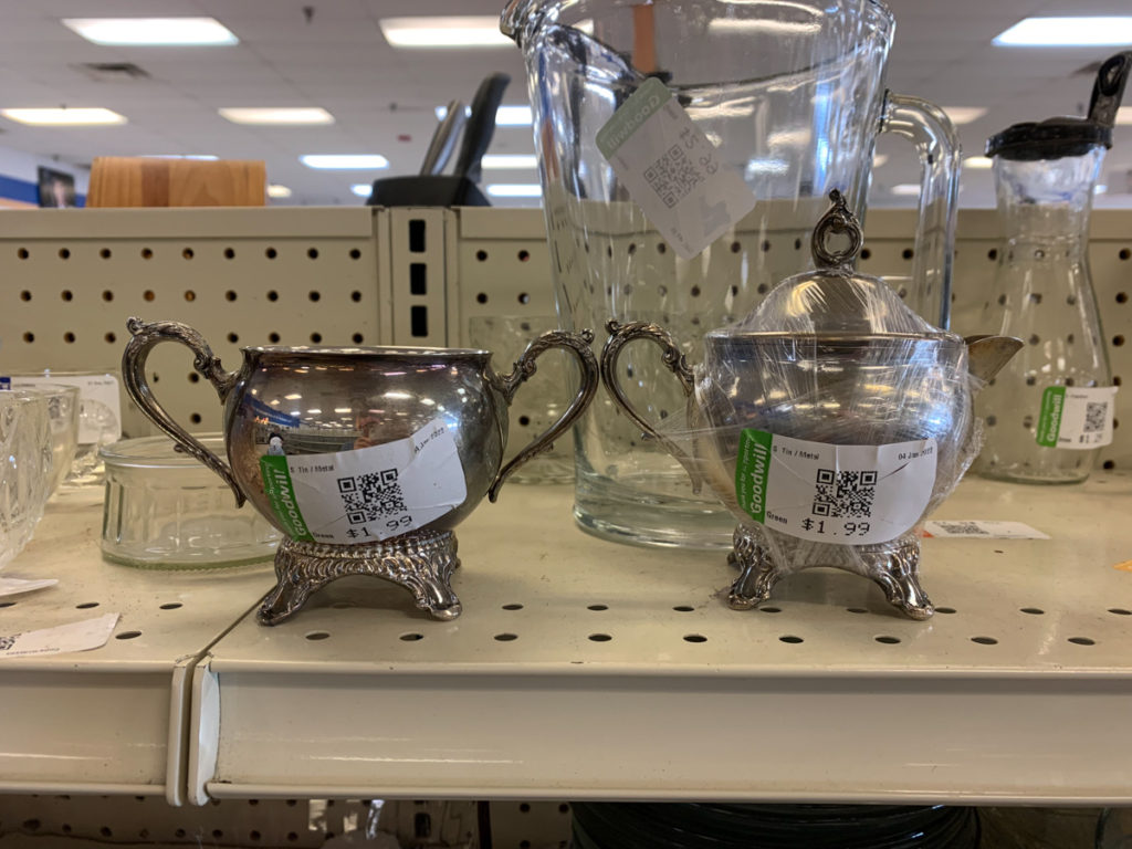 vintage silver for sale on the shelf at the thrift store 