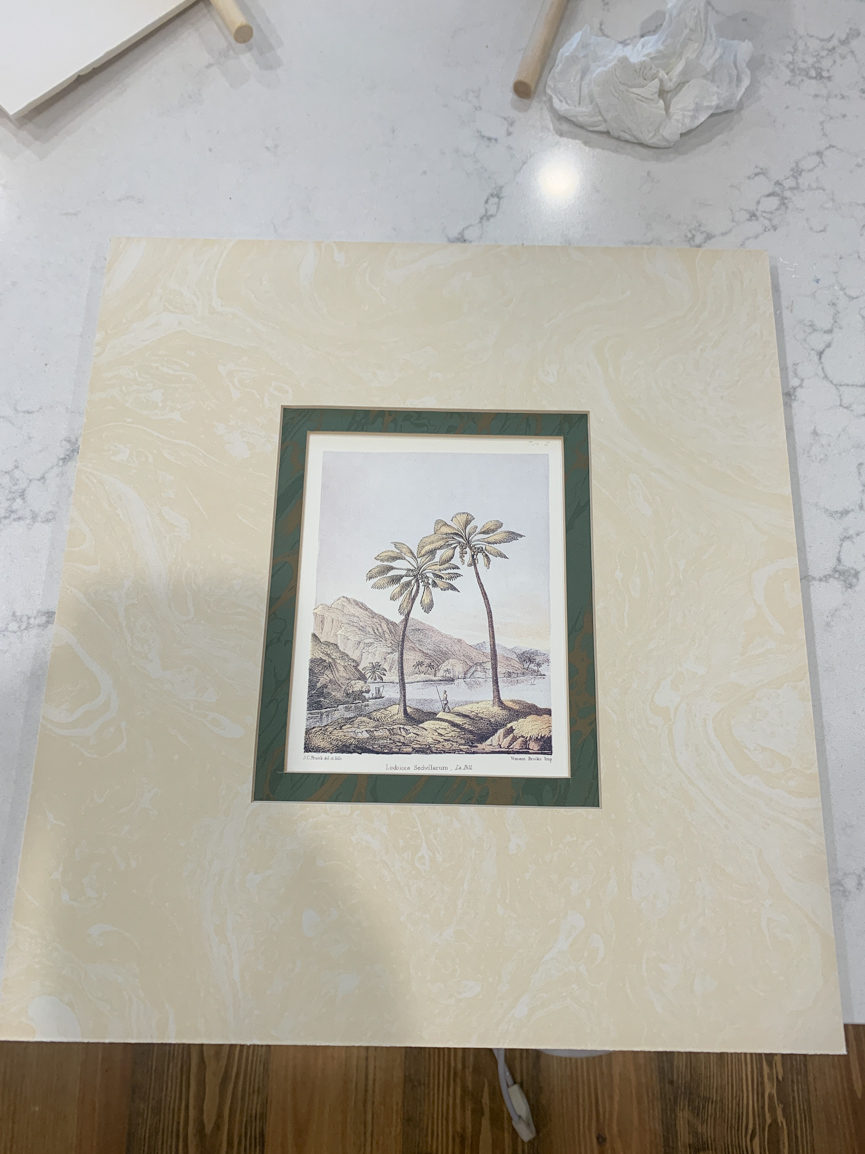 a picture mat with a print of palm trees inside 