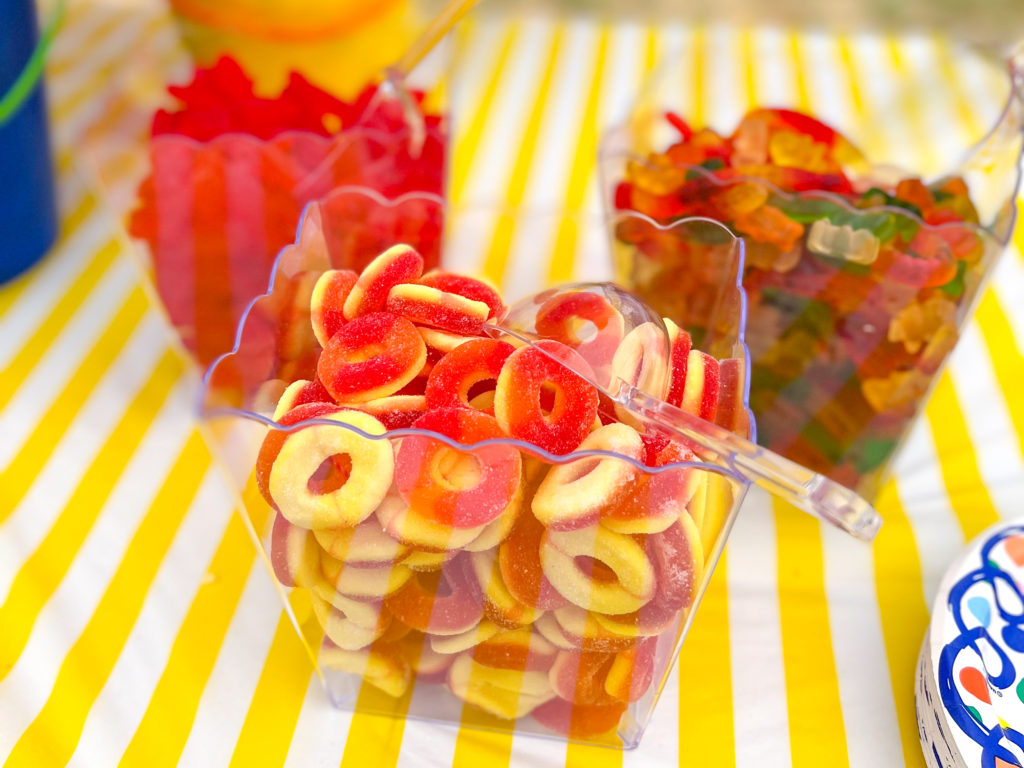 candy displayed on a party table in clear containers 