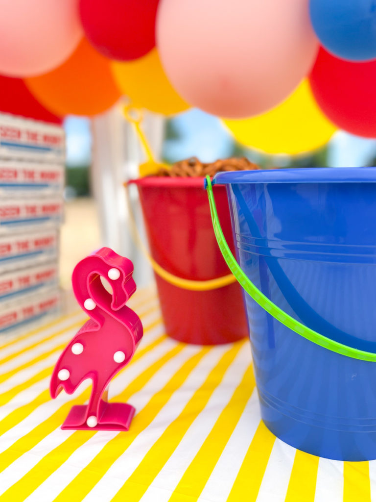 a decorative pink flamingo on the table at a summer waterslide birthday party 