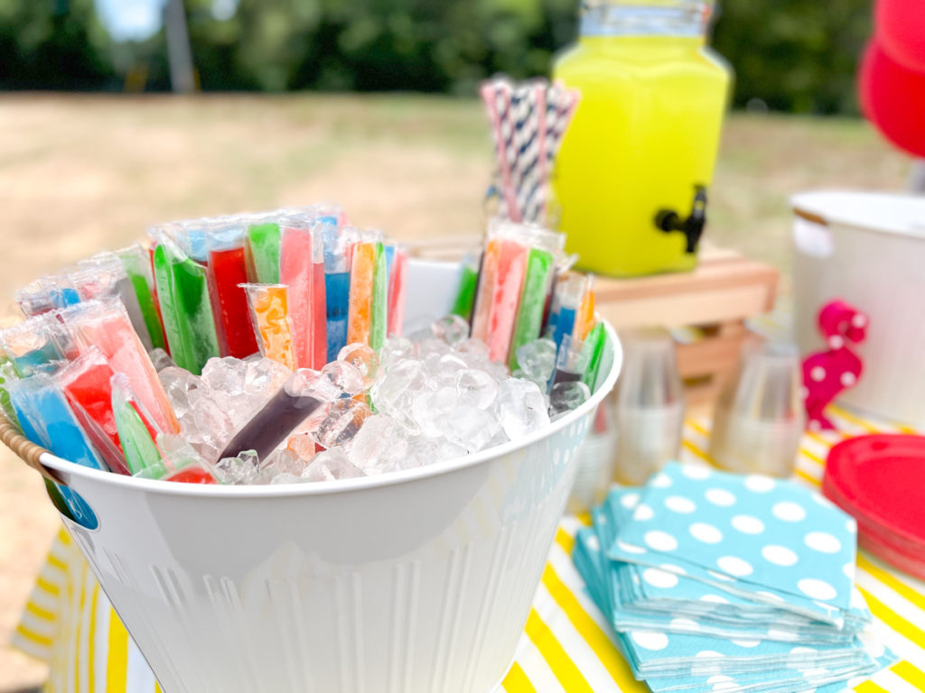 frozen popsicles in a beverage tub at a summer waterslide birthday party 