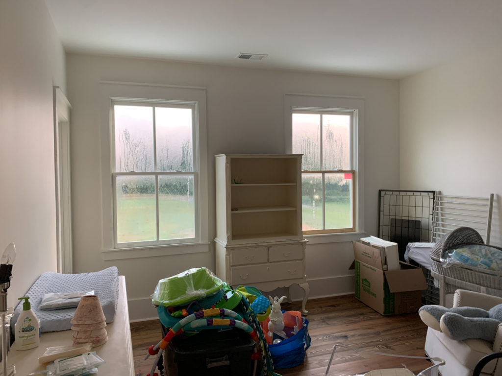 before photo of nursery with boxes and furniture on the ground