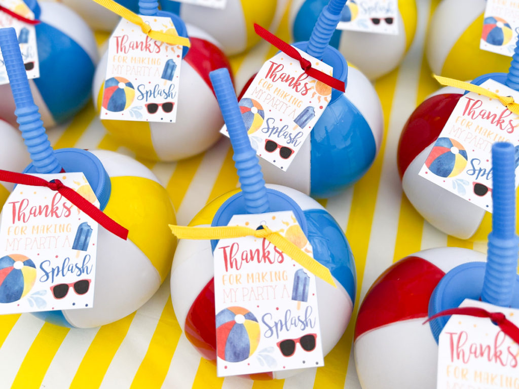 beach ball cup party favors with a thank you tag tied on with ribbon 