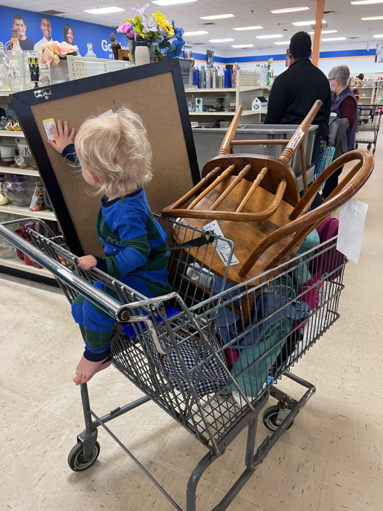 thrift store buggy full of furniture and a frame