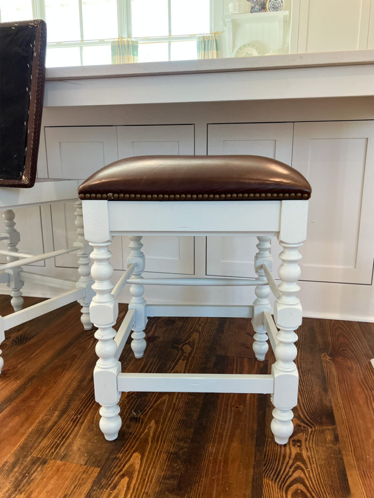 a painted barstool makeover with a leather seat cushion 