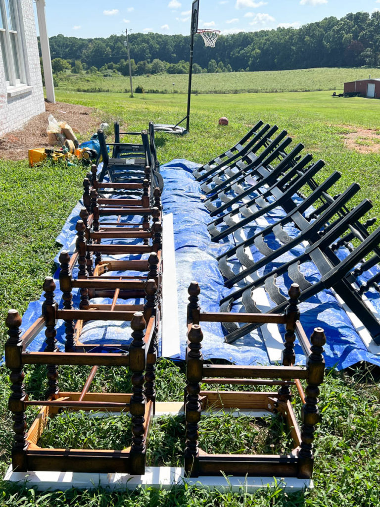 barstools and chairs outside on a tarp ready to be painted