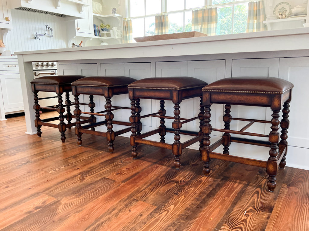 four dark wood barstools before they were painted 