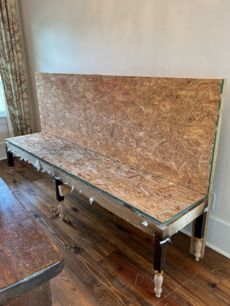 the construction of a DIY banquette bench using 2x4's and plywood to create the frame 