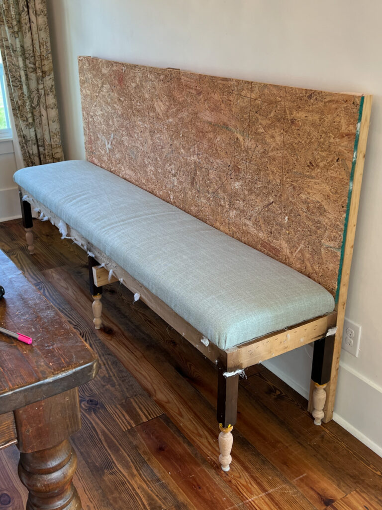 the construction process of a DIY banquette bench with an upholstered seat cushion 