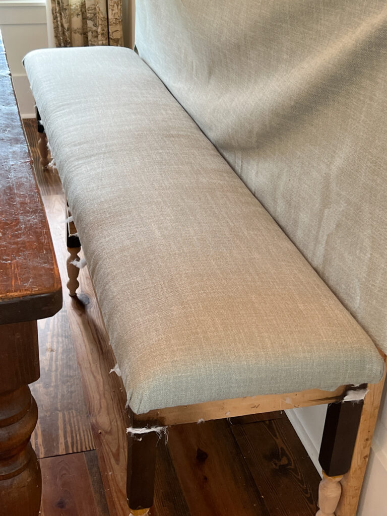 the construction process of a DIY banquette bench with an upholstered seat cushion 