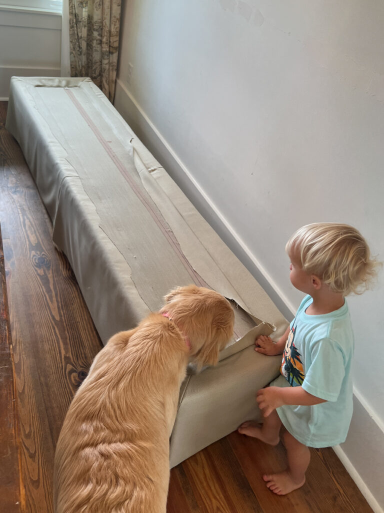 an old upholstered bench being deconstructed and taken apart to turn it into a banquette