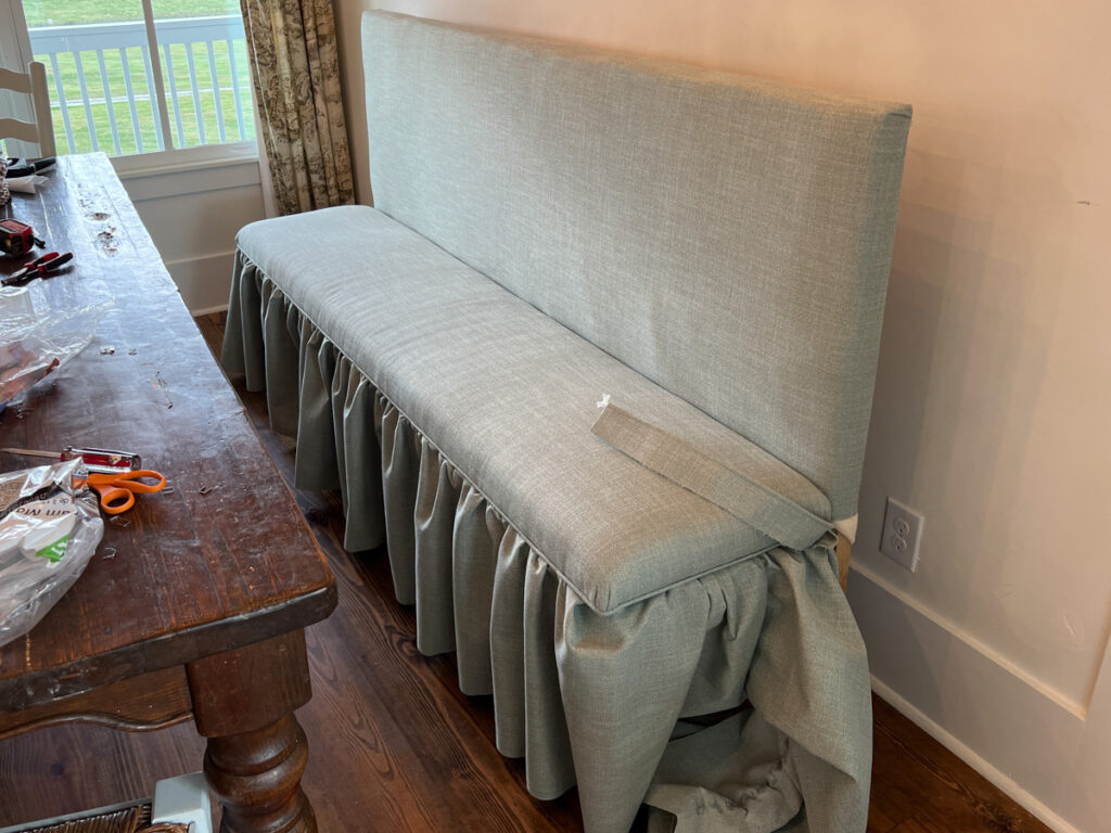 adding piping and a ruffled skirting detail to an upholstered DIY banquette bench 