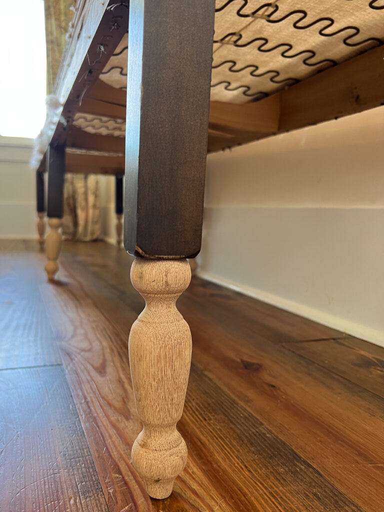 close up photo of wood furniture legs added to a bench to give it additional height 