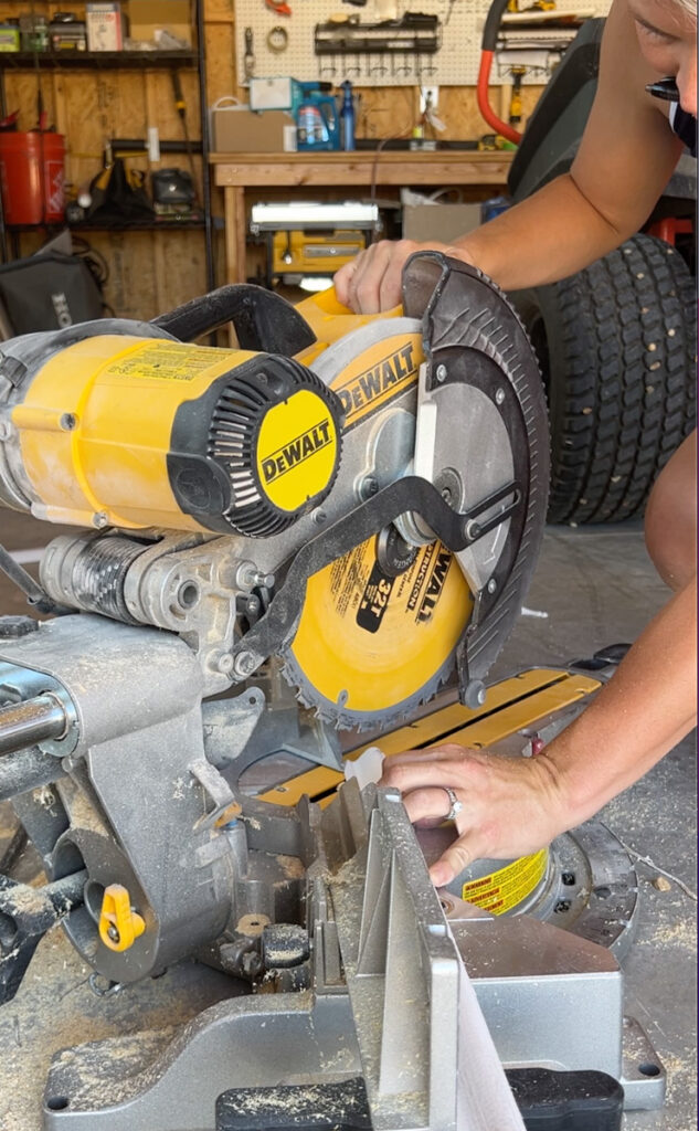 dewalt miter saw cutting a piece of wood trim 