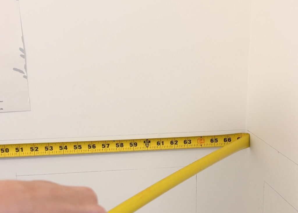 tape measure measuring the width of a wall 