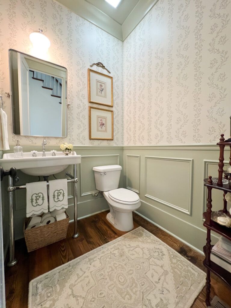 picture frame molding on the walls of a powder bathroom