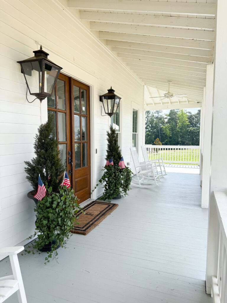 a white farmhouse with a painted or stained porch floor