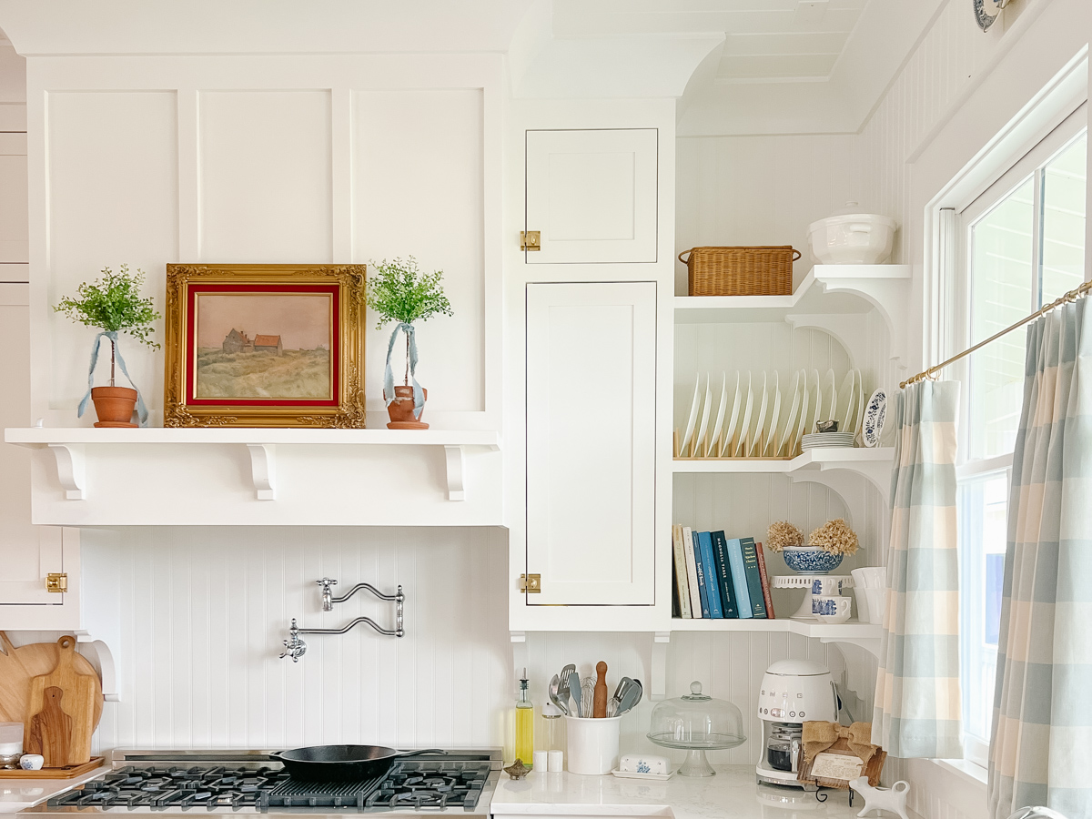 white farmhouse kitchen with open shelving and beadboard backplash